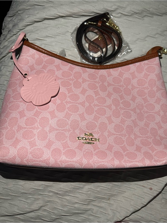 Coach Handbags - Coach Pink Signature Canvas Shoulder Bag with Flower Charm and Brown Trim.